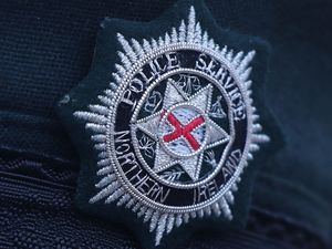 A Police Service of Northern Ireland logo badge