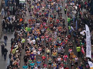 Runners cross Tower Bridge during the 2024 London Marathon