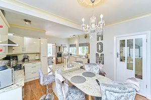 There's a modern kitchen with a breakfast bar