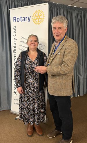 Caption: President Johnathan Callwood presents latest Shrewsbury Severn Rotary Club member Gemma Wasteney with her lapel badge.