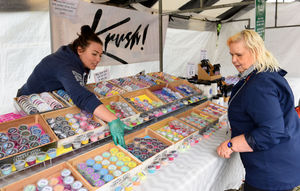 Natasha Childs of Krush Cosmetics serves a customer as the market gets back underway in Cannock