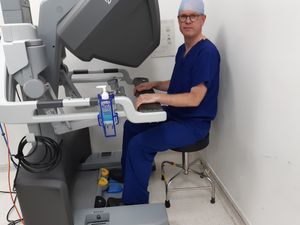 Consultant surgeon Mr Adam Farquharson sitting at the controls of the robot. Picture: LDRS