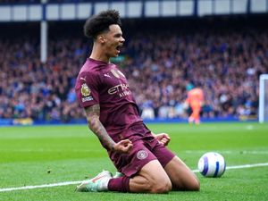 Manchester City’s Nico O’Reilly slides and shouts in delight after scoring at Goodison Park.