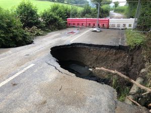 Supporting image for story: Road collapse as storms lead to travel disruption and flooding of properties