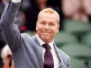 Sir Chris Hoy waves to the crowd from the Wimbledon Royal Box