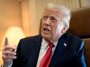 President Donald Trump speaks to reporters aboard Air Force One