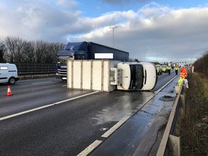 The overturned van was left on its side on the M6 after the crash. Image: Highways England