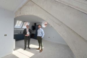 Liam Floyd shows Mark Andrews the impressive roof beams of the upper courtroom