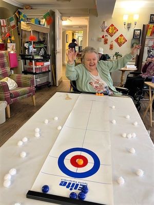 Resident Freda Manning going for gold in the tabletop curling event