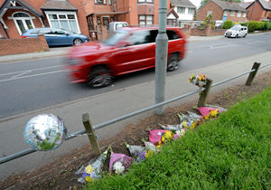 The scene on Prestwood Road, Wolverhampton, where tributes have been left for Shakur Pinnock