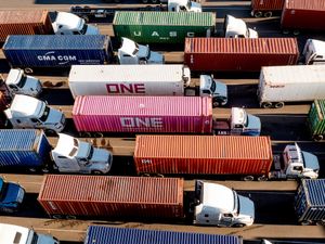 Trucks line up to enter a Port of Oakland shipping terminal