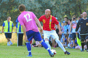Llion Jenkins for Mach tries to stop Micky Thomas