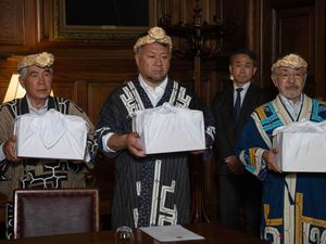 Mr Okawa Masaru, executive director of the Ainu Association of Hokkaido with Tetsuya Ogawa and Yoshiyuki Uji holding the skulls during the formal repatriation ceremony