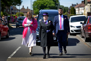 Isabella's parents Mark Lyttle and Jennie Dalton walk down Mill Street after her funeral 