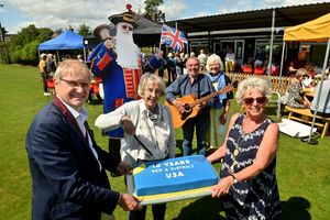 Wem Mayor David Parry with founding member Jean Norton, 90, and Chair of the group Enid Smith cutting the cake
