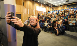 Maisie takes a selfie with students at Birmingham City University
