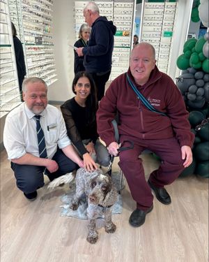 The team at Specsavers Shifnal Hearing alongside Hearing Dogs volunteer Phil and Hearing Dog Rolo