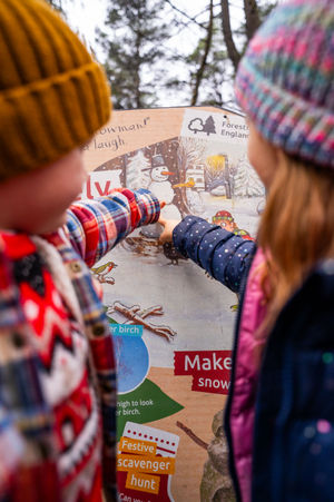 Children interacting with the Christmas Stick Man display boards.