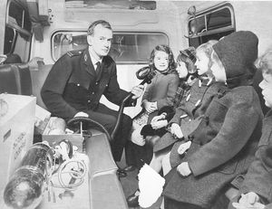 Chadsmoor Infants School, Cannock. The school was running a project about "people who help us" and visited ambulance headquarters in Stafford. The photograph shows Deputy Station Officer Nevil Haughton demonstrating oxygen equipment to the children, January 1974.