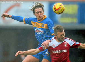 Tom Eaves of Shrewsbury Town and Darren Ward of Swindon Town.