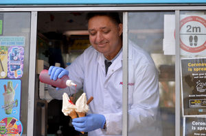 Joga Singh serves ice cream from the Mr Simon ice cream van as people enjoy a day out at Walsall Arboretum