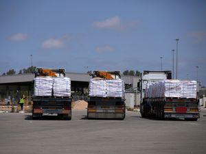 Trucks carrying humanitarian aid for the Gaza Strip at the Kerem Shalom Crossing in southern Israel
