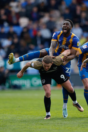 Chey Dunkley of Shrewsbury Town and Colby Bishop of Portsmouth (AMA)