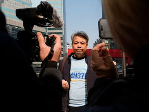 Jiang Hui, whose mother was on the missing MH370 Malaysia Airlines passenger jet, wears a shirt saying Remembering 239 Lives, MH370 as he talks to media on the 11th anniversary of the jet going missing in Beijing, China