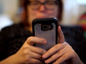 A blurred woman using a mobile phone