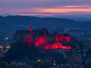 Edinburgh Castle lit up in red