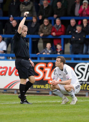 Shaun Whalley of AFC Telford United is shown a yellow card