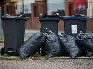 Rubbish bags piled up in front of bins in Moseley Road, Birmingham