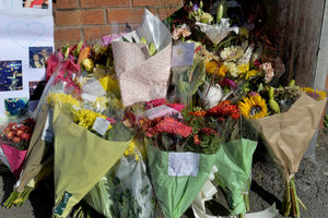 Some of the flowers left at the scene