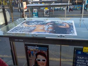 A photograph on top of a bus shelter