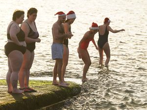 A group of people getting in the sea