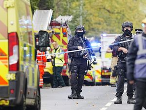 Armed police officers at the scene of an incident at Heaton Park Hebrew Congregation synagogue in Crumpsall, Manchester, where police have shot a suspect after several people were stabbed and a car was driven at members of the public