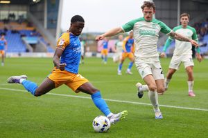 Ismeal Kabia of Shrewsbury Town and Zak Bradshaw of Cambridge United