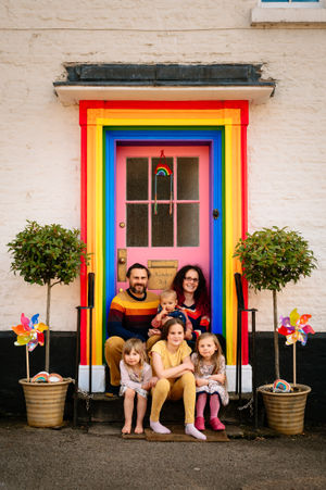 KIDDERMINSTER COPYRIGHT EXPRESS & STAR JAMIE RICKETTS 05/05/2020 - A family from Bewdley, who run Glow Bambino, have painted their front door in Rainbow colours to spead joy during the Coronavirus Pandemic and support key works. In Picture: The Hemmings Family - L>R: Giles Hemmings, Scarley Hemmings 5 (front right), Bracken Hemmings (19 months middle top), Fearne Hemmings 11 (middle bottow), Sara Hemmings and Autumn Hemmings 7 (bottom right)....