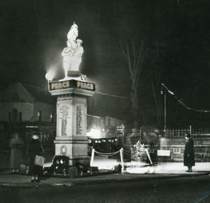 Visitors pay respects as Cannock War Memorial is illuminated for Armistice Week, in November 1938