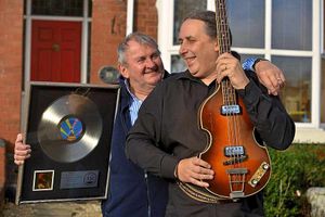 Son Chris and Kelly's brother Tony with the star's bass.