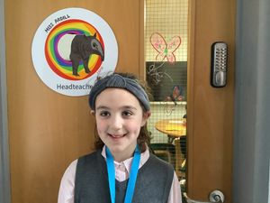Headteacher for the day Fern Ardill, aged eight, outside her office at Coleham Primary School