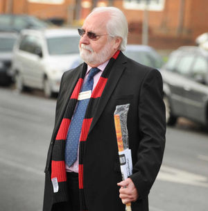 Councillor John Edwards walks past the demonstration