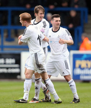 Neill Byrne of AFC Telford United celebrates after scoring a goal to make it 2-0 with Mike Grogan and Matty McGinn