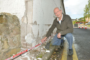 Neil Owen outside his damaged house
