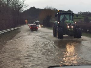 Traffic pushing through standing water on the Welshpool-Shrewsbury road on Tuesday afternoon. Photo: Barry Evans
