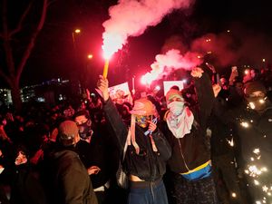 People light flares as they protest in Istanbul