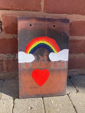 A decorated tile which one neighbour gave to Eva