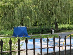 A tent was seen between the river and the children's play area