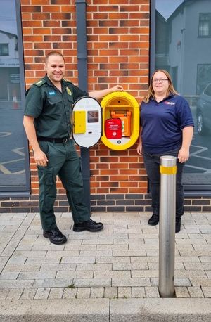 WMAS Community Response Manager Tim Cronin and North Warwickshire CFR, Sam Hall, install a bleed control kit at AAA Food Hall in Hartshill.