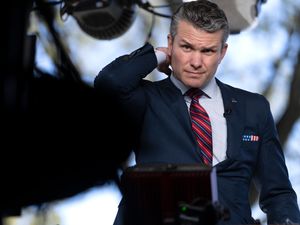 Pete Hegseth scratching his neck